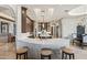 Gourmet kitchen with stone accents, large island, breakfast bar, and adjoining dining area at 11773 E Desert Trail Rd, Scottsdale, AZ 85259
