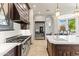 Gourmet kitchen with large island, stainless steel appliances, and ample cabinet space at 11773 E Desert Trail Rd, Scottsdale, AZ 85259