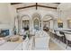Open concept living room with a fireplace, beautiful arches, and comfortable seating to entertain Gathering and friends at 11773 E Desert Trail Rd, Scottsdale, AZ 85259