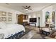Spacious living area featuring a kitchenette, tile floors, comfortable seating, and a cozy bedroom area at 11773 E Desert Trail Rd, Scottsdale, AZ 85259