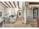 Elegant living space has a stone fireplace, decorative pillars, and access to the front entrance at 11773 E Desert Trail Rd, Scottsdale, AZ 85259