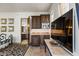 Open living area featuring a kitchenette with custom cabinets and stainless appliances, a bathroom, and bedroom area at 11773 E Desert Trail Rd, Scottsdale, AZ 85259