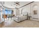 Expansive main bedroom with a tray ceiling, fan, decorative fireplace, sitting area, and scenic views at 11773 E Desert Trail Rd, Scottsdale, AZ 85259
