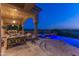 Inviting outdoor space with a covered patio, comfortable seating, and a pool with scenic views at 11773 E Desert Trail Rd, Scottsdale, AZ 85259