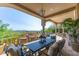 Expansive covered patio boasts luxurious seating, dining, and picturesque views of the desert landscape at 11773 E Desert Trail Rd, Scottsdale, AZ 85259