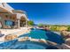 Inviting pool with rock features and a tanning shelf offers stunning outdoor living with desert views at 11773 E Desert Trail Rd, Scottsdale, AZ 85259