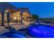 Backyard featuring a pool with stone accents and a spacious patio for outdoor entertaining at 11773 E Desert Trail Rd, Scottsdale, AZ 85259