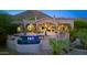 Inviting backyard featuring a pool with a water feature and spacious patio, set against a mountain backdrop at 11773 E Desert Trail Rd, Scottsdale, AZ 85259