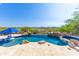Stunning pool offers a built-in spa and beautiful desert views in a luxurious backyard setting at 11773 E Desert Trail Rd, Scottsdale, AZ 85259