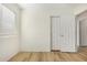 Bedroom showcasing wood flooring, neutral paint, and bright window at 1447 E 12Th Pl, Casa Grande, AZ 85122