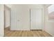 Bedroom showcasing wood flooring and two closet doors, offering ample storage at 1447 E 12Th Pl, Casa Grande, AZ 85122
