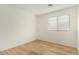 Bedroom showcasing wood flooring, neutral paint, and bright window at 1447 E 12Th Pl, Casa Grande, AZ 85122