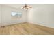 An empty bedroom showcasing wood flooring, neutral paint, and bright window at 1447 E 12Th Pl, Casa Grande, AZ 85122