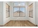 Bright dining room featuring wood flooring and large windows, offering natural light at 1447 E 12Th Pl, Casa Grande, AZ 85122