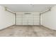 Spacious garage with an overhead door and concrete flooring, ready for parking and storage at 1447 E 12Th Pl, Casa Grande, AZ 85122