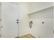 Bright laundry room with a utility sink, overhead shelf, and washer/dryer hookups at 1447 E 12Th Pl, Casa Grande, AZ 85122