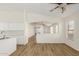 Bright living room showcasing neutral paint, wood floors, and an archway to the next room at 1447 E 12Th Pl, Casa Grande, AZ 85122