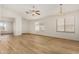Inviting living room with wood floors, abundant natural light, and contemporary ceiling fan at 1447 E 12Th Pl, Casa Grande, AZ 85122