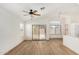 Open-concept living area boasts wood floors, sliding doors, and adjacent modern kitchen at 1447 E 12Th Pl, Casa Grande, AZ 85122