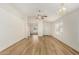 Spacious living room showcasing wood floors, natural light, and a modern ceiling fan at 1447 E 12Th Pl, Casa Grande, AZ 85122