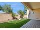 Relaxing backyard featuring a stone waterfall feature and manicured artificial grass at 14844 W Pershing St, Surprise, AZ 85379