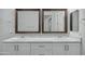 Bathroom featuring a double sink vanity with white cabinets, granite countertop, and bronze framed mirrors at 14844 W Pershing St, Surprise, AZ 85379
