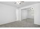 Neutral bedroom with carpet, ceiling fan, bright window, and large closet with mirrored doors at 14844 W Pershing St, Surprise, AZ 85379