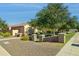 Attractive single-story home with desert landscaping and a low decorative wall at 14844 W Pershing St, Surprise, AZ 85379