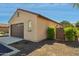 Home exterior shows a two car garage, a small garden area, and side gate at 14844 W Pershing St, Surprise, AZ 85379