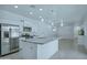 Well-lit kitchen featuring stainless steel appliances and a spacious island at 14844 W Pershing St, Surprise, AZ 85379
