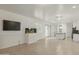 Open-concept living space with tile flooring and a dedicated space for entertainment at 14844 W Pershing St, Surprise, AZ 85379