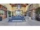 Community lobby featuring a rustic fireplace, wood benches with blue cushions, and hanging chandeliers at 14844 W Pershing St, Surprise, AZ 85379