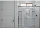 Modern walk-in shower with glass door and bright lighting, next to bathroom door at 14844 W Pershing St, Surprise, AZ 85379