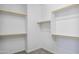 Open walk-in closet featuring white shelving and hanging space for optimal storage at 14844 W Pershing St, Surprise, AZ 85379
