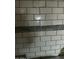 Tile bathroom wall featuring subway-style tiles and a decorative accent band at 150 S Windsor Dr # 35, Mesa, AZ 85204
