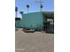 Turquoise mobile home with a gravel yard, patio, and mature trees at 150 S Windsor Dr # 35, Mesa, AZ 85204