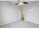 Cozy bedroom featuring a ceiling fan, carpeted floor and closet with doors at 1584 E Harrison E St, Chandler, AZ 85225
