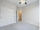 Spare bedroom featuring a ceiling fan, carpeted floor and closet with doors at 1584 E Harrison E St, Chandler, AZ 85225