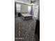 Bright bedroom features two windows, soft carpet, and a glimpse of a luxurious ensuite bathroom at 17423 W Country Club Ter, Surprise, AZ 85387