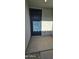 Inviting entryway featuring a dark-colored front door and concrete patio at 17423 W Country Club Ter, Surprise, AZ 85387