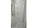 Hallway features large white closet doors and tile flooring connecting the bathroom at 17423 W Country Club Ter, Surprise, AZ 85387