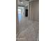 Bright hallway featuring tile flooring and neutral-toned walls leading to an outdoor patio at 17423 W Country Club Ter, Surprise, AZ 85387