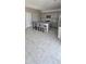 Stylish kitchen featuring gray cabinetry, granite countertops, a center island with seating, and tile flooring at 17423 W Country Club Ter, Surprise, AZ 85387