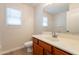 Bathroom with wood cabinets, sink, and a mirror at 18123 W Lundberg St, Surprise, AZ 85388