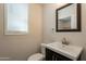 Powder room features a modern vanity and sink, updated toilet, and window with natural light at 18123 W Lundberg St, Surprise, AZ 85388