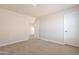 Carpeted bedroom showcases neutral walls, a closet, and a doorway leading to the hallway at 18123 W Lundberg St, Surprise, AZ 85388