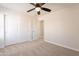 Spacious bedroom features carpet, ceiling fan, and closet at 18123 W Lundberg St, Surprise, AZ 85388