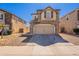 Two-story home featuring stone accents, a two-car garage and low-maintenance landscaping in a residential neighborhood at 18123 W Lundberg St, Surprise, AZ 85388