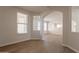 Open-concept living area with hardwood floors, archways, neutral walls, with view into another room at 18123 W Lundberg St, Surprise, AZ 85388