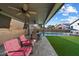 Inviting outdoor living area with an outdoor kitchen, pool, and comfortable seating arrangement at 19002 N 25Th Pl, Phoenix, AZ 85050